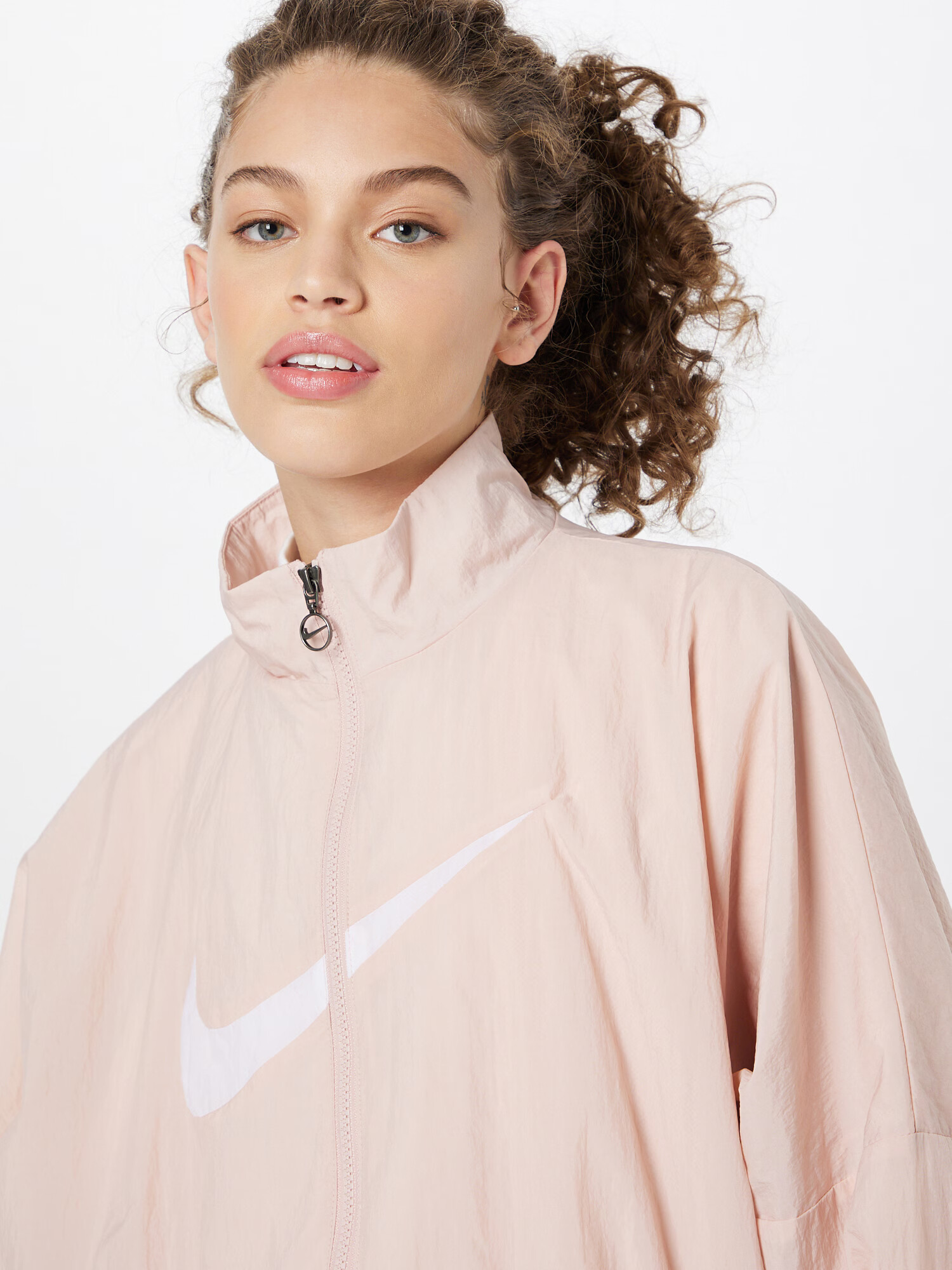 Nike Sportswear Prehodna jakna pastelno roza / bela - Pepit.si