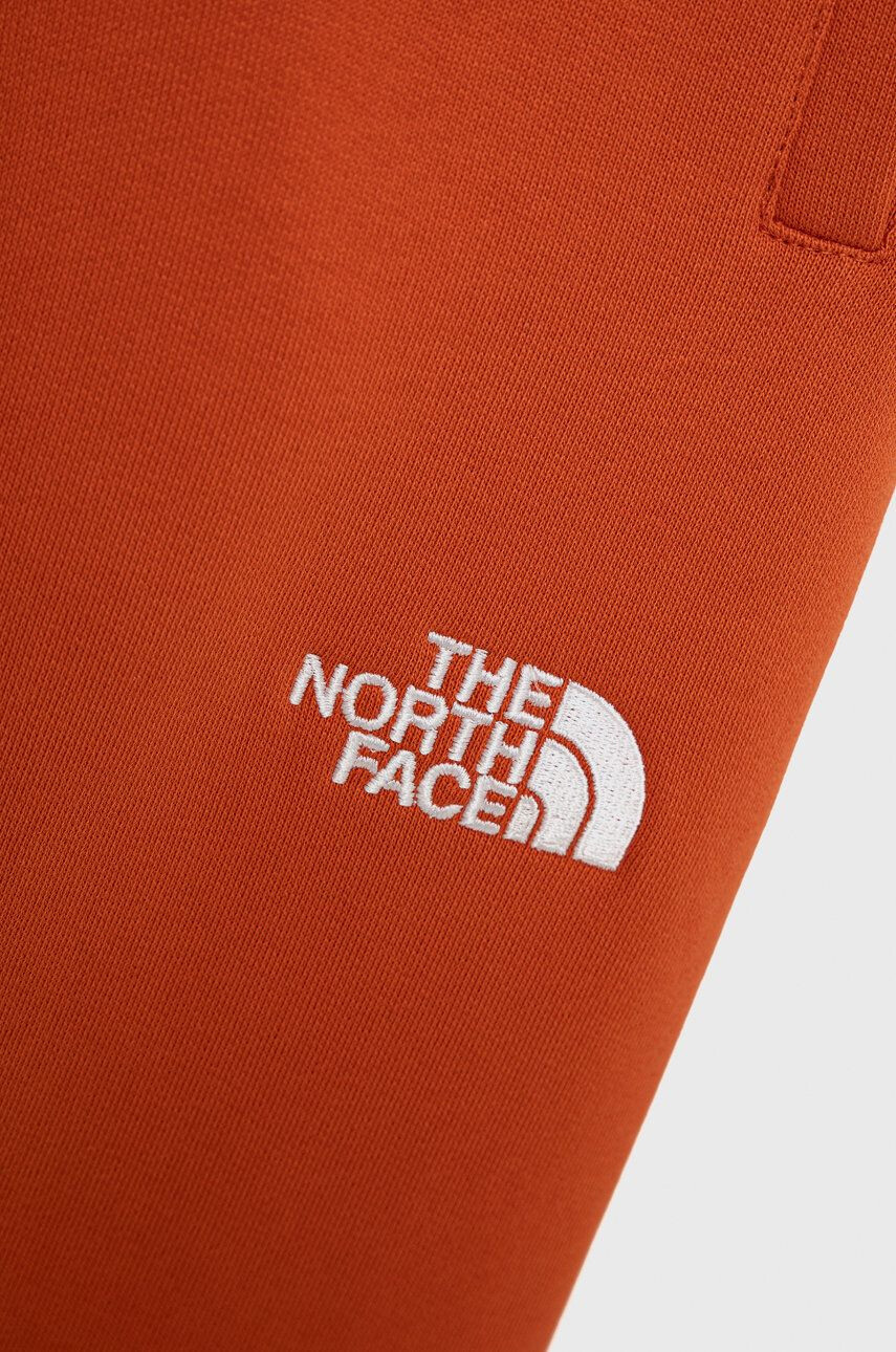 The North Face Otroške bombažne hlače oranžna barva - Pepit.si