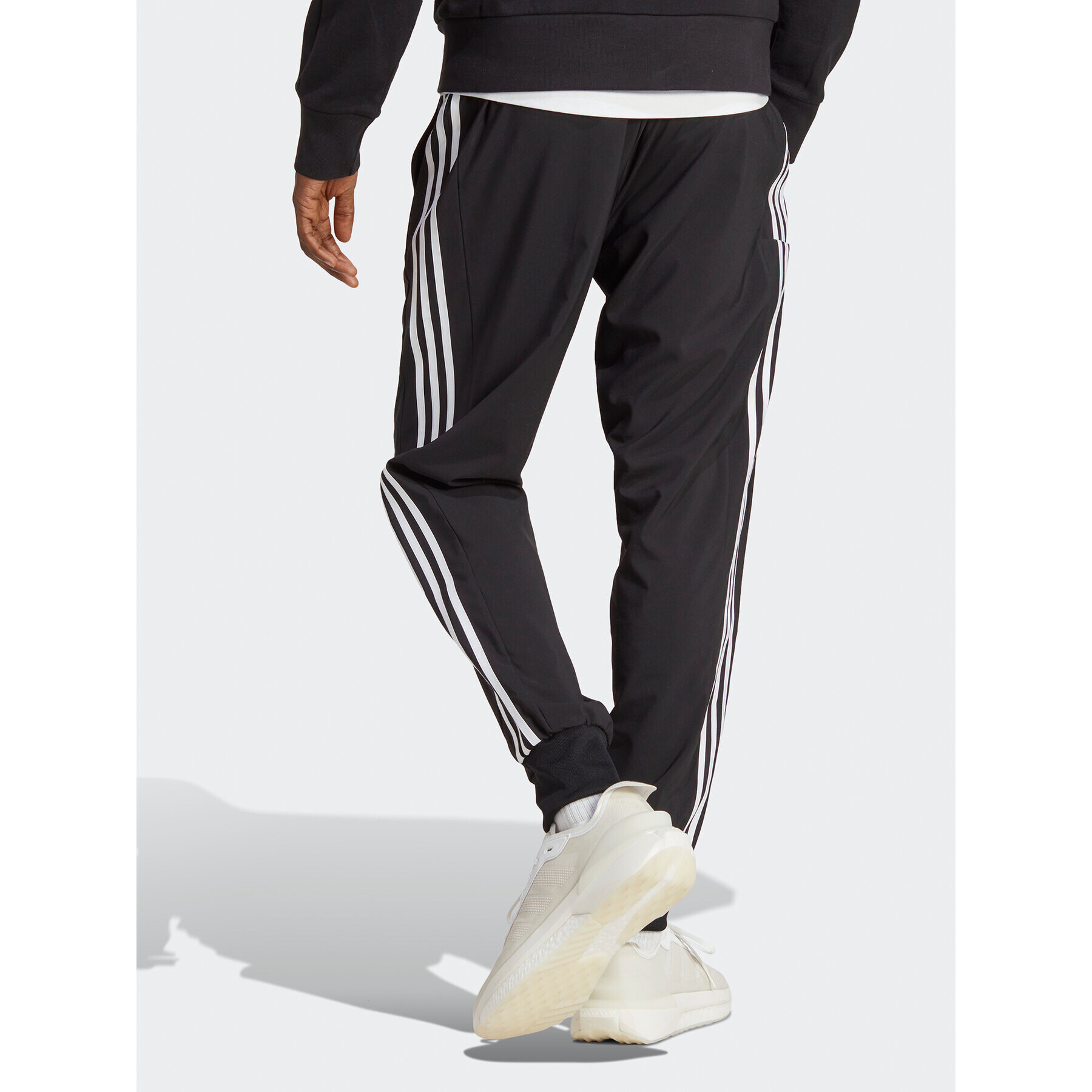 adidas Spodnji del trenirke AEROREADY Essentials Tapered Cuff Woven 3-Stripes Joggers IC0041 Črna Regular Fit - Pepit.si