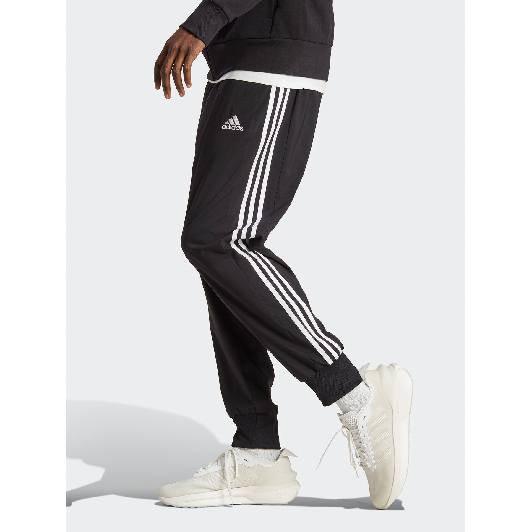 adidas Spodnji del trenirke AEROREADY Essentials Tapered Cuff Woven 3-Stripes Joggers IC0041 Črna Regular Fit - Pepit.si