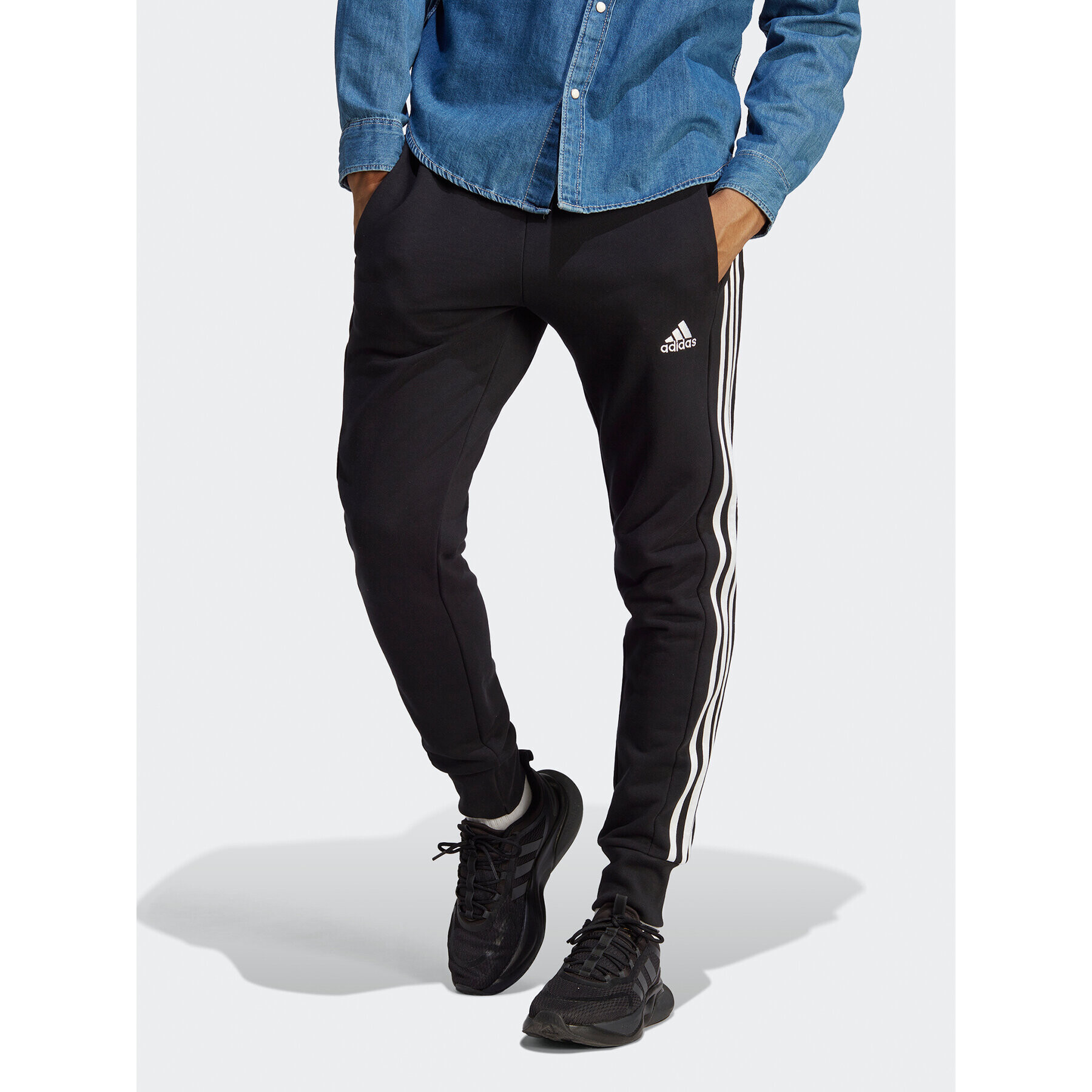 adidas Spodnji del trenirke Essentials French Terry Tapered Cuff 3-Stripes Joggers HA4337 Črna Regular Fit - Pepit.si