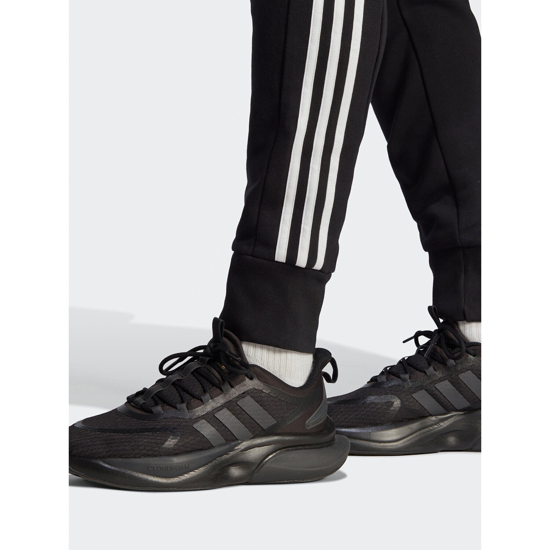 adidas Spodnji del trenirke Essentials French Terry Tapered Cuff 3-Stripes Joggers HA4337 Črna Regular Fit - Pepit.si