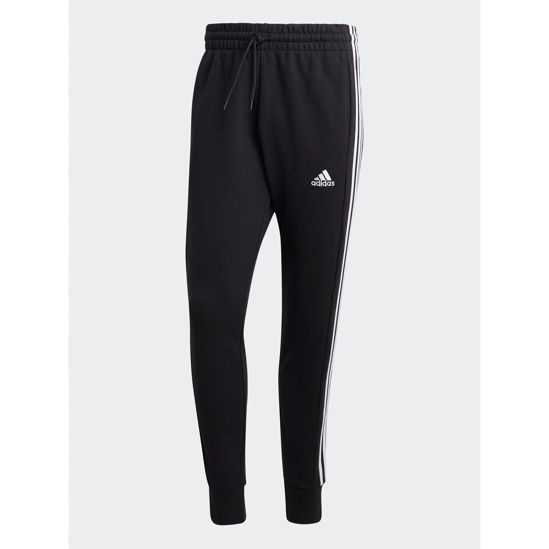 adidas Spodnji del trenirke Essentials French Terry Tapered Cuff 3-Stripes Joggers HA4337 Črna Regular Fit - Pepit.si