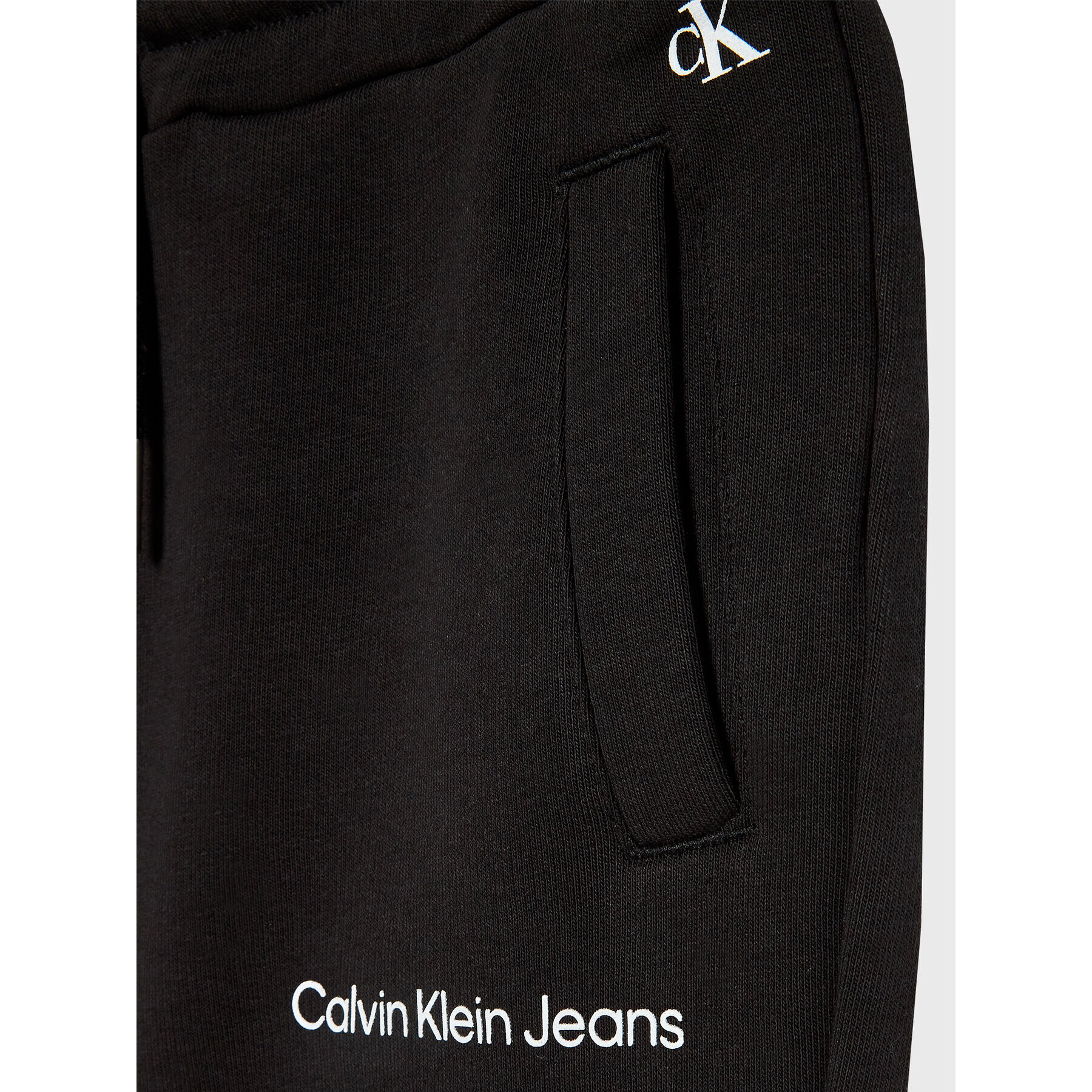 Calvin Klein Jeans Spodnji del trenirke Logo IG0IG01509 Črna Relaxed Fit - Pepit.si