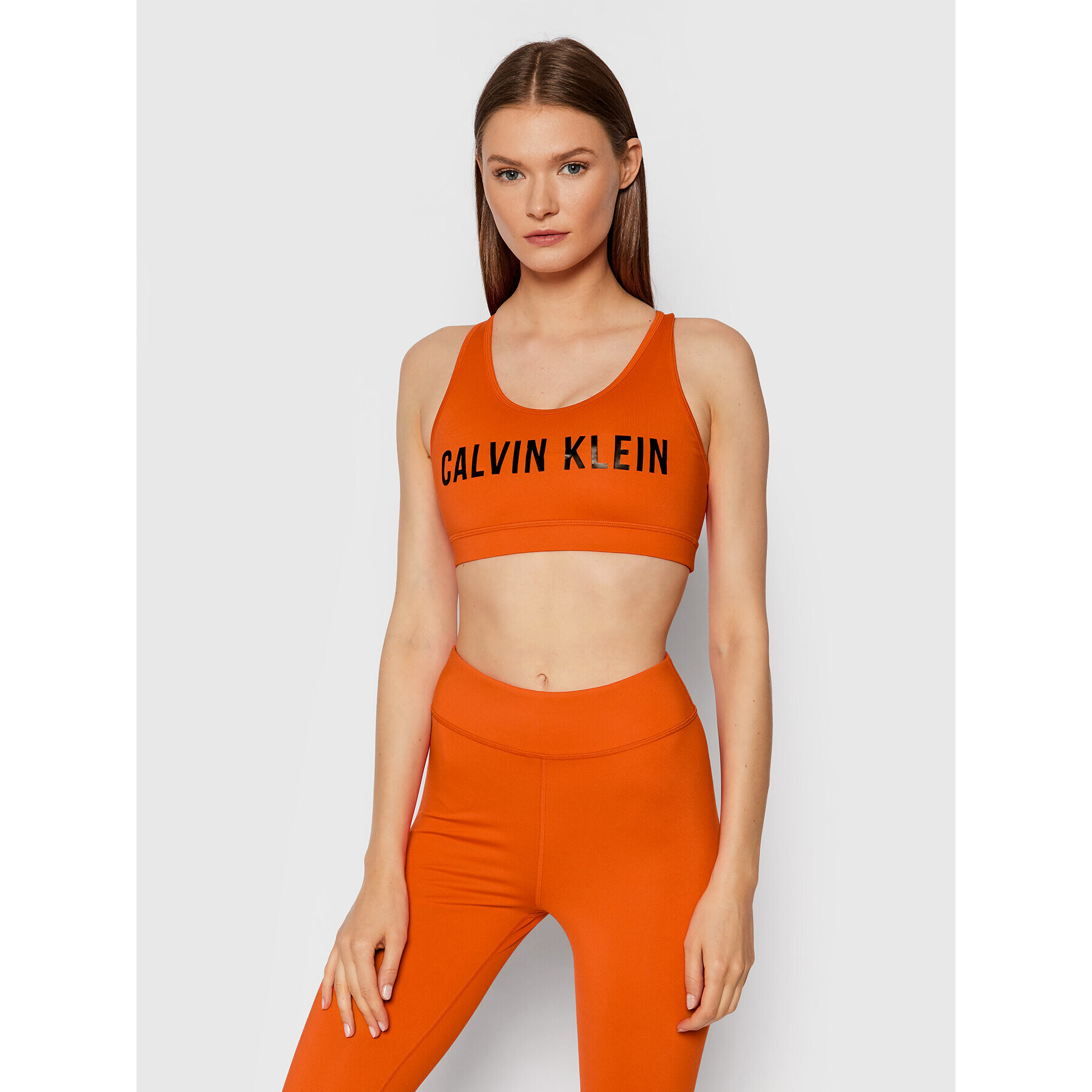 Calvin Klein Performance Špotni nedrček Medium Support 00GWF0K157 Oranžna - Pepit.si