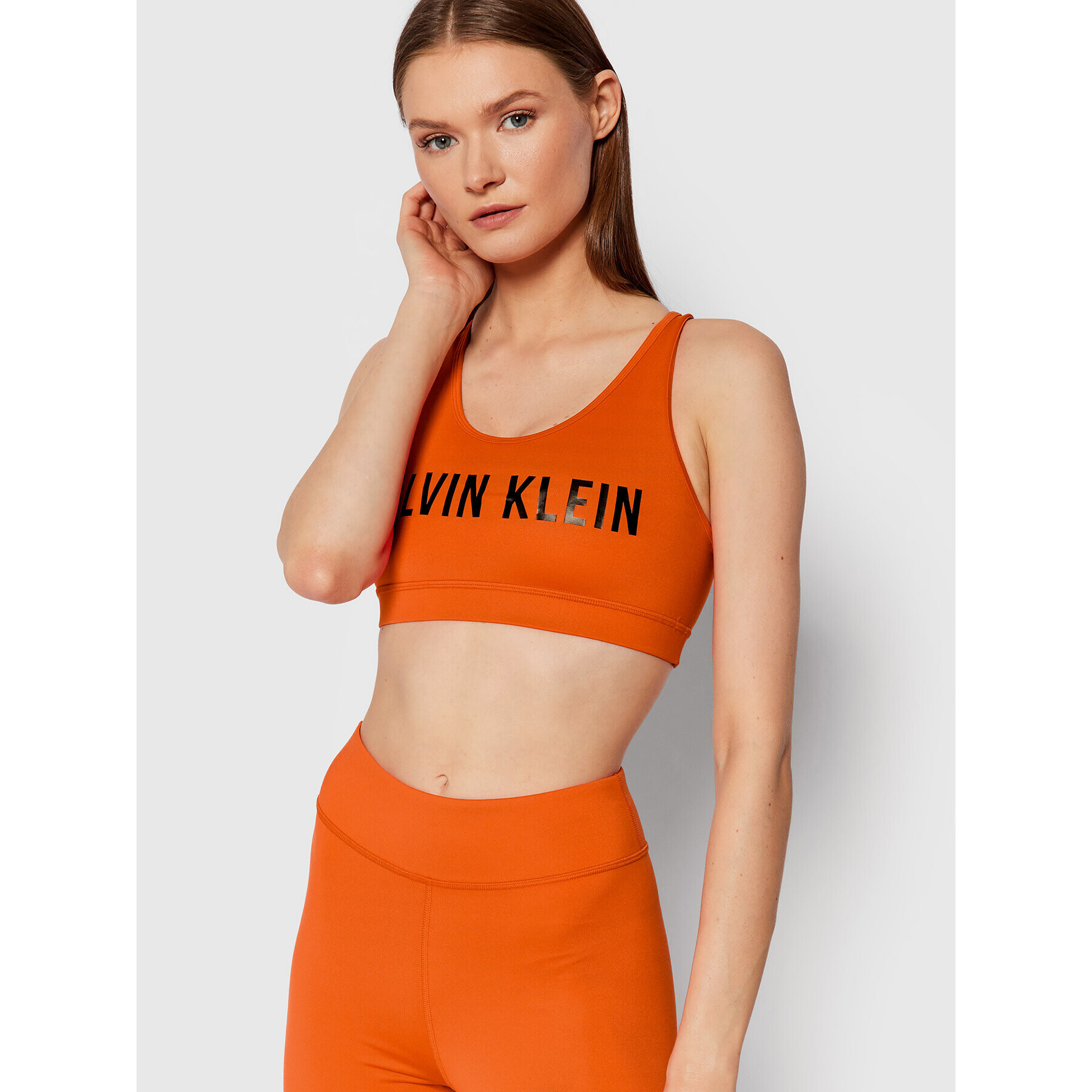 Calvin Klein Performance Špotni nedrček Medium Support 00GWF0K157 Oranžna - Pepit.si