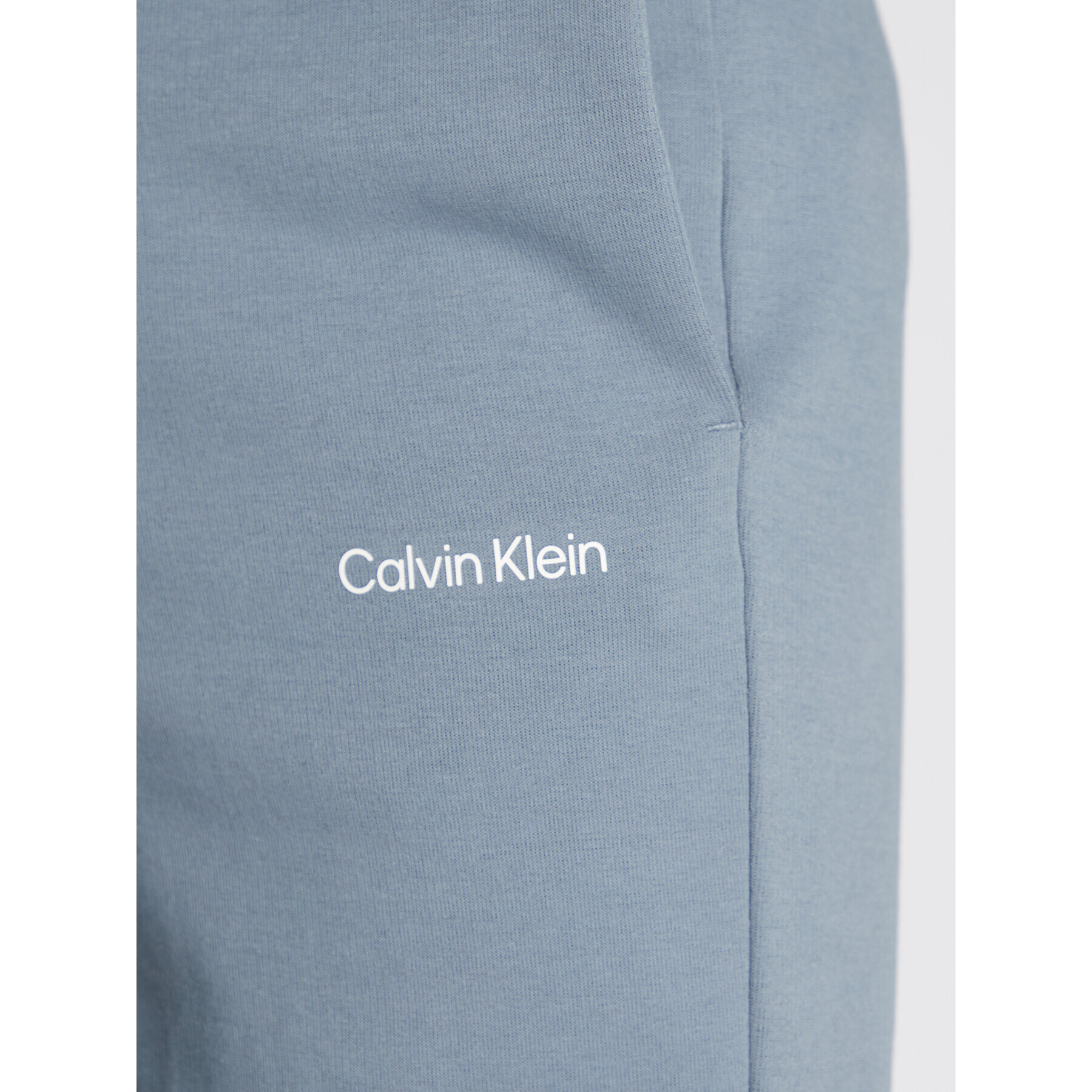 Calvin Klein Spodnji del trenirke Micro Logo K10K109940 Siva Relaxed Fit - Pepit.si