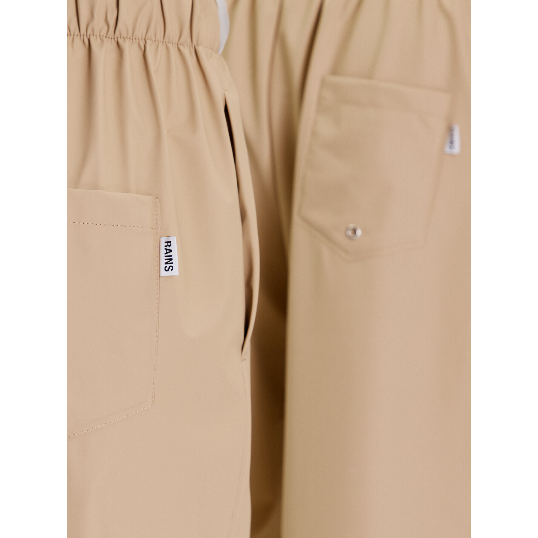 Rains Hlače iz tkanine Unisex 18560 Bež Comfortable Fit - Pepit.si