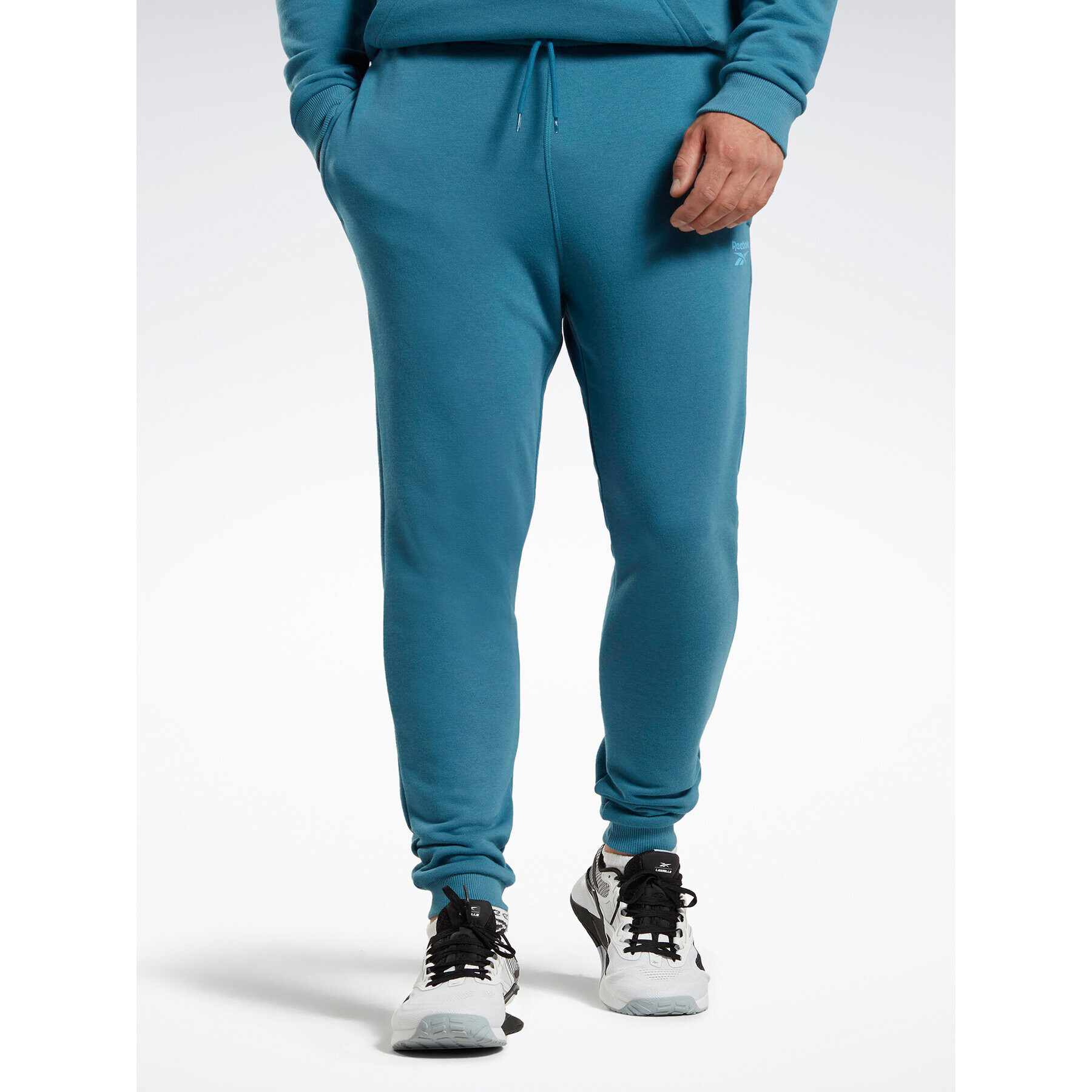 Reebok Spodnji del trenirke Identity French Terry Joggers H49680 Modra Regular Fit - Pepit.si