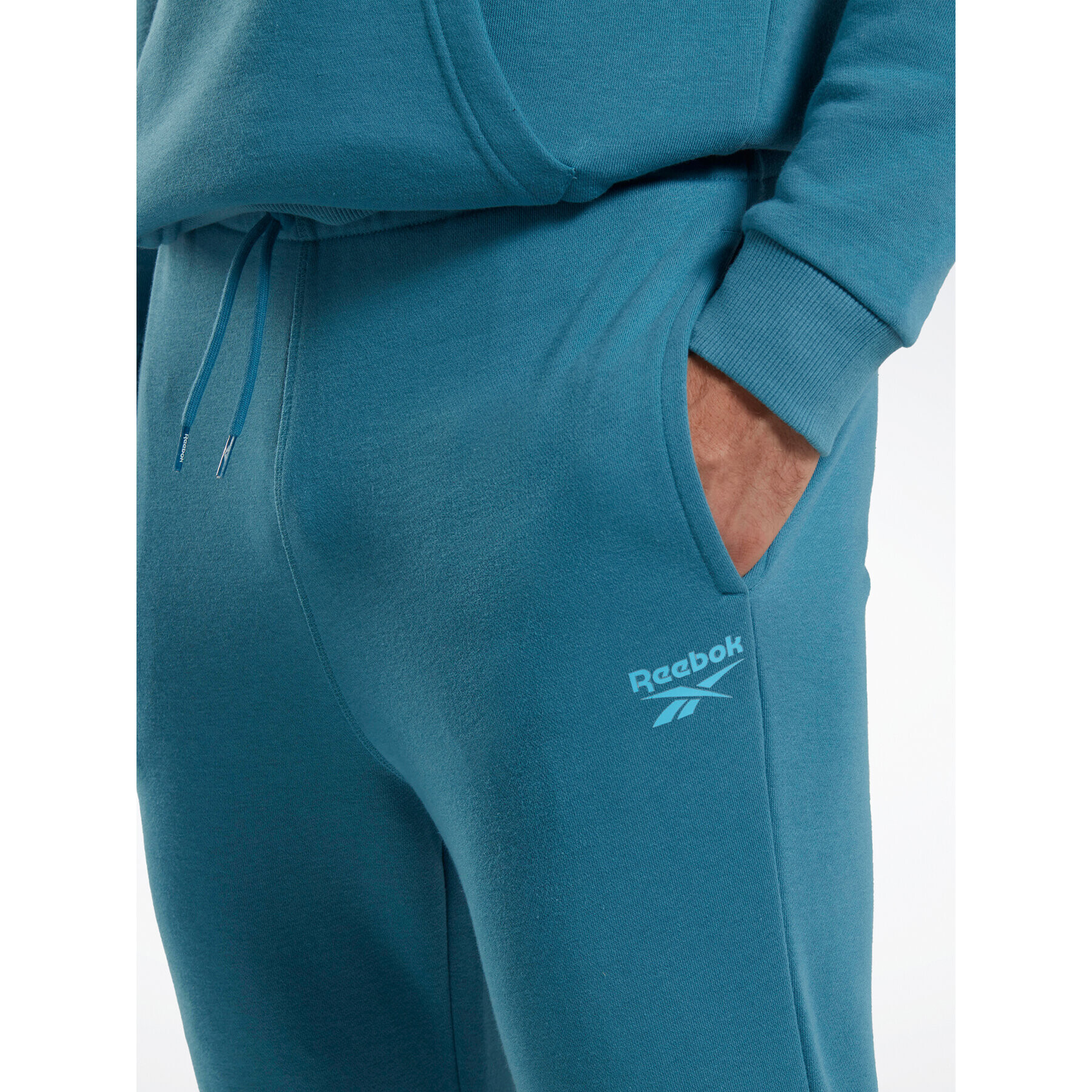 Reebok Spodnji del trenirke Identity French Terry Joggers H49680 Modra Regular Fit - Pepit.si